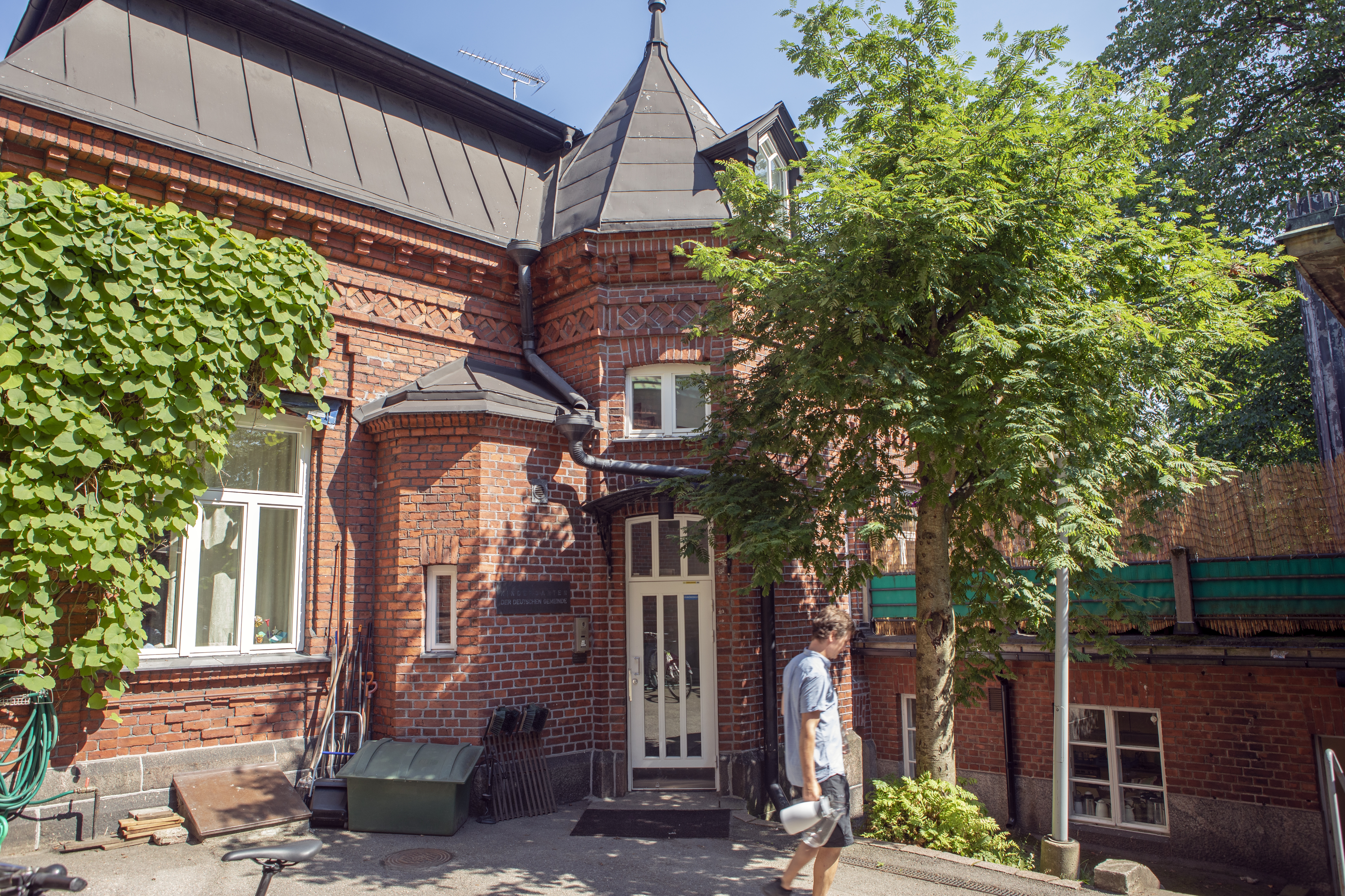 Kirkon vehreä umpipiha muistuttaa luostaria. Kuvan rakennuksessa on vasemmalla kirkkoherran asunto, keskellä pappila toimistotiloineen, päiväkoti sekä oikealla alhaalla seurakunnan keittiö.