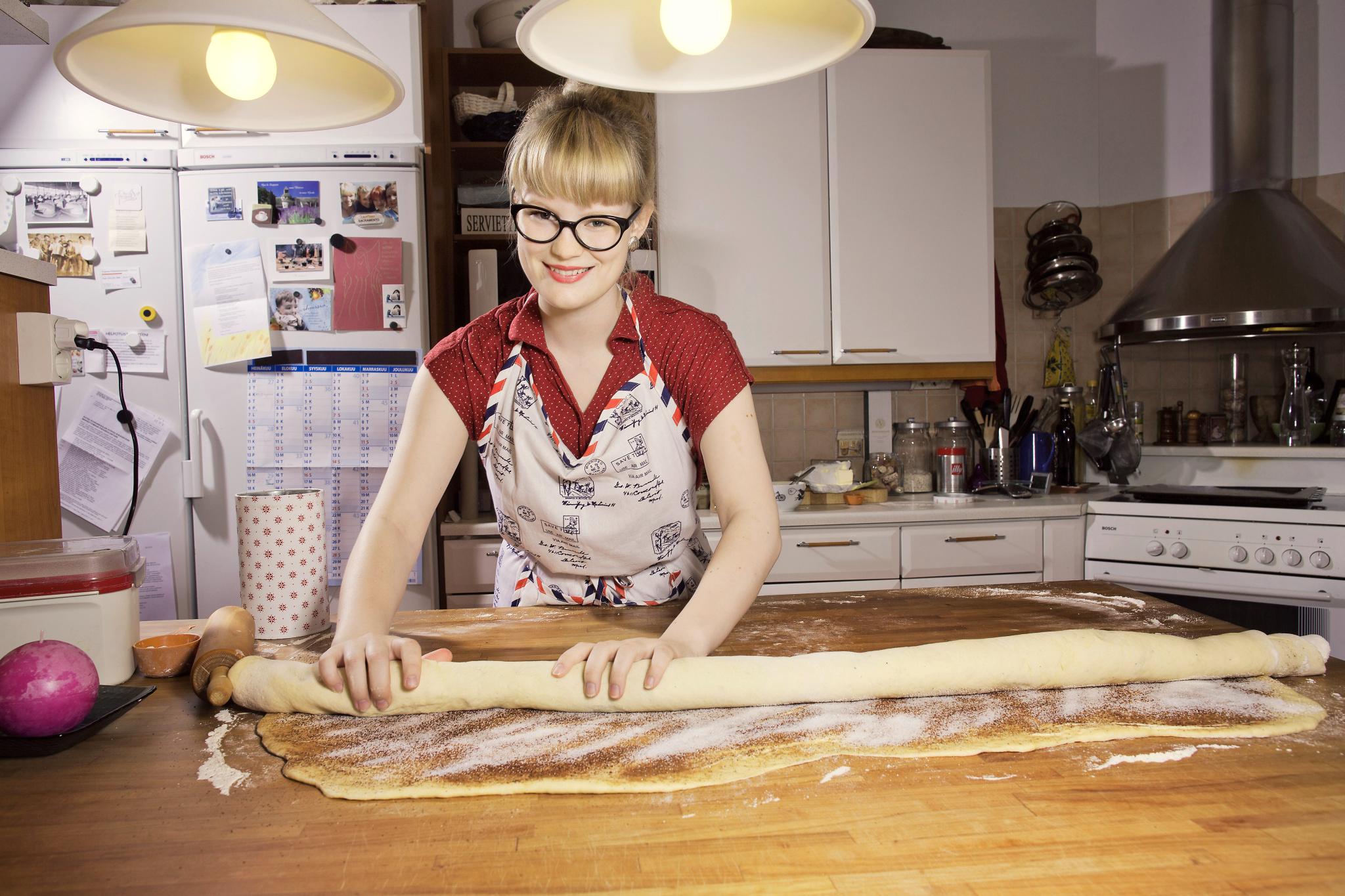 Hyvän korvapuustin salaisuus on taikinan kauliminen henkäyksen ohueksi. Tia Vähäsarjalta isonkin pullaerän leipominen ja paistaminen sujuu iloisella rutiinilla vielä kotona Espoon Rastaalassa, vaikka hän oli samassa puuhassa vuoden ajan lähes päivittäin vapaaehtoistöissä Belgiassa. Kuva: Jani Laukkanen