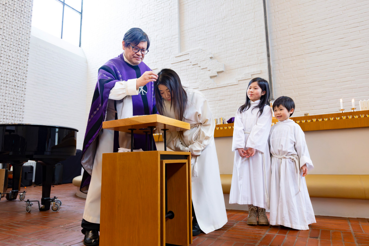 Pastori Paulos Huang kastoi Mandy Liun ja hänen lapsensa Cherien ja Leonin kiinankielisessä messussa Alppilan kirkossa maaliskuun alussa.
