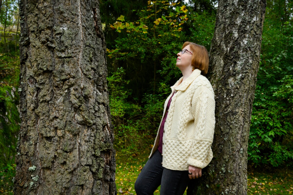 Metsämieli-kävelyiden vetäjä Päivi Turiainen etsi nojaamispaikan kahden koivun välistä.