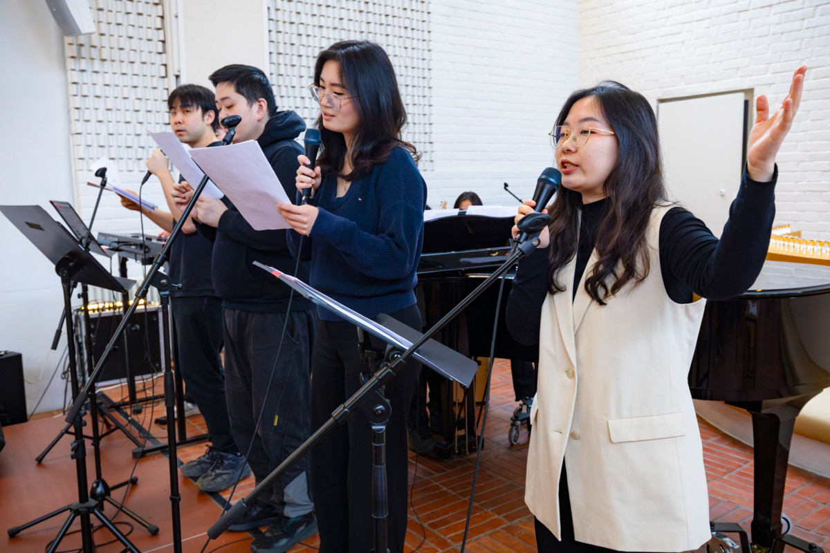 Nuorten bändi ja kuoro soittavat ja laulavat messussa. Välillä mukana on bändin jäsenten muusikkokavereita. Kuvassa oikealla on Yinxin Shen.