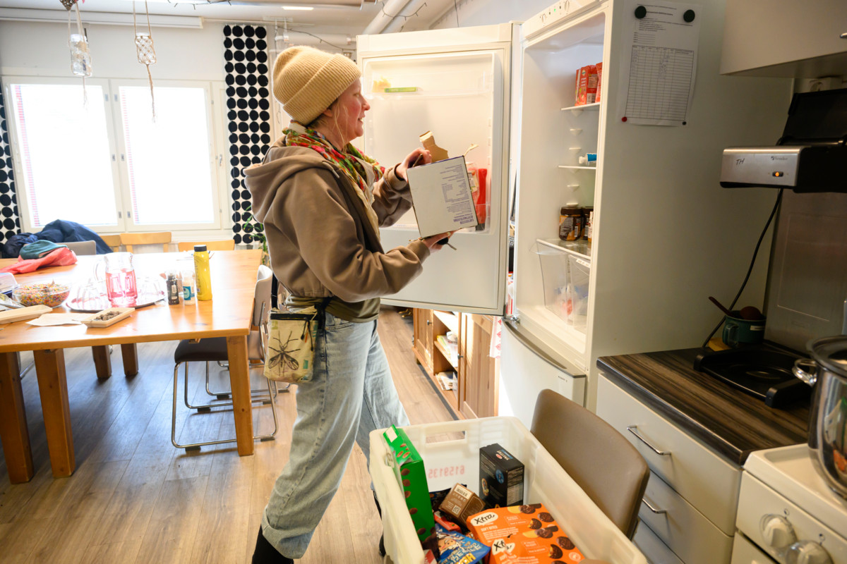 Stadin yhteisötalo Pihlajamäkeen on juuri tuotu hävikkiruokatoimitus ja yhteisökoordinaattori Satu Punju purkaa saatuja tuotteita jääkaappiin.