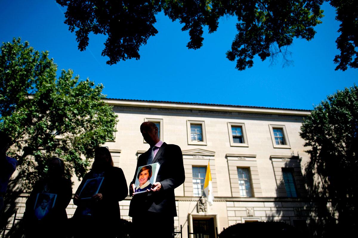 Ihmiset osoittivat mieltä Washingtonissa Vatikaanin suurlähetystön ulkopuolella 30. elokuuta. Mielenosoittajat kantoivat seksuaalisen hyväksikäytön uhriksi joutuneen Barbara Blainen kuvaa. Kuva: Brendan Smialowski − AFP