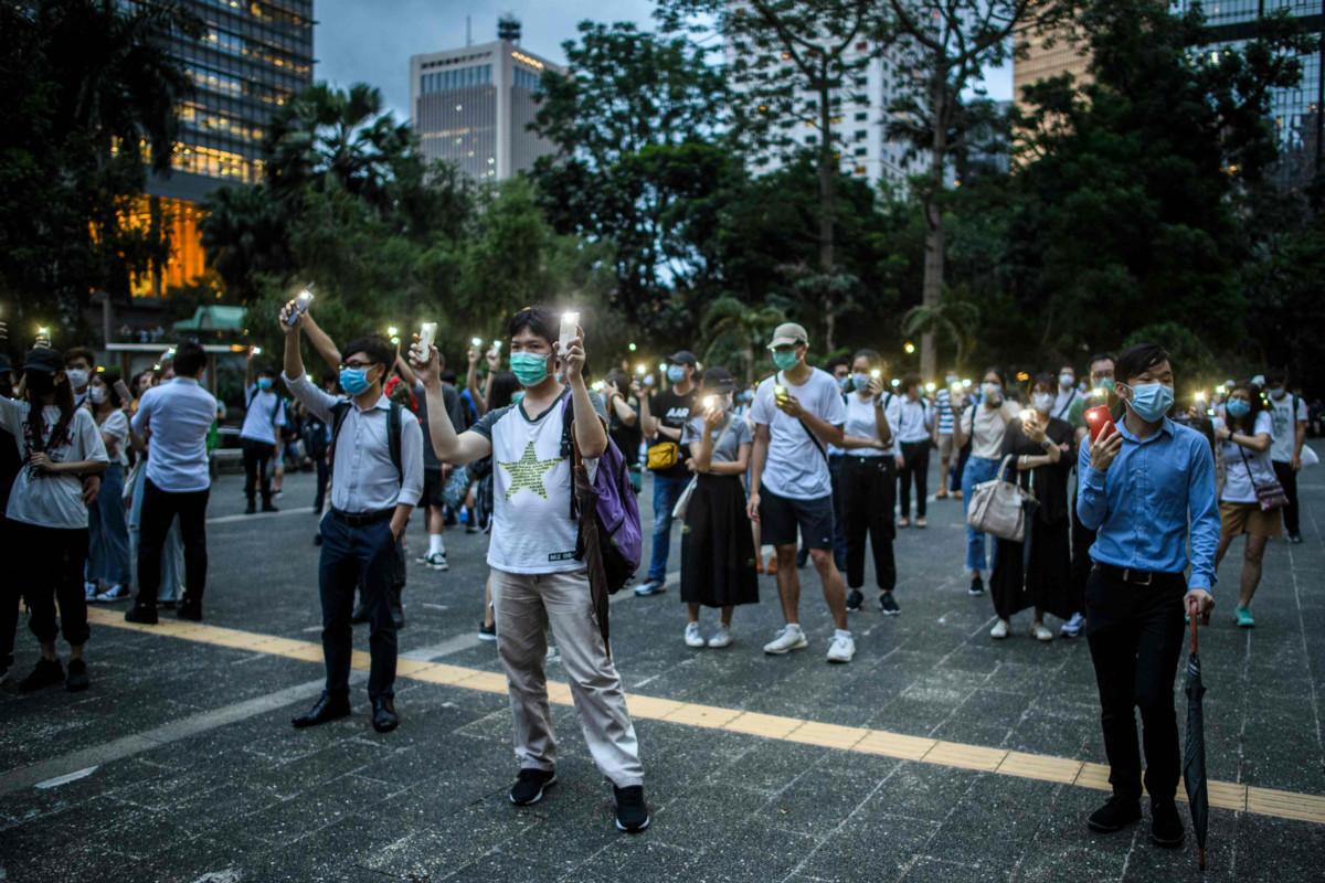 Demokratiaa puolustava mielenosoitus Hongkongissa 9. kesäkuuta, protestien alkamisen vuosipäivänä. Mielenosoittajilla on maskit ja koronan vuoksi vaadittu turvaväli. LEHTIKUVA / AFP Anthony Wallace