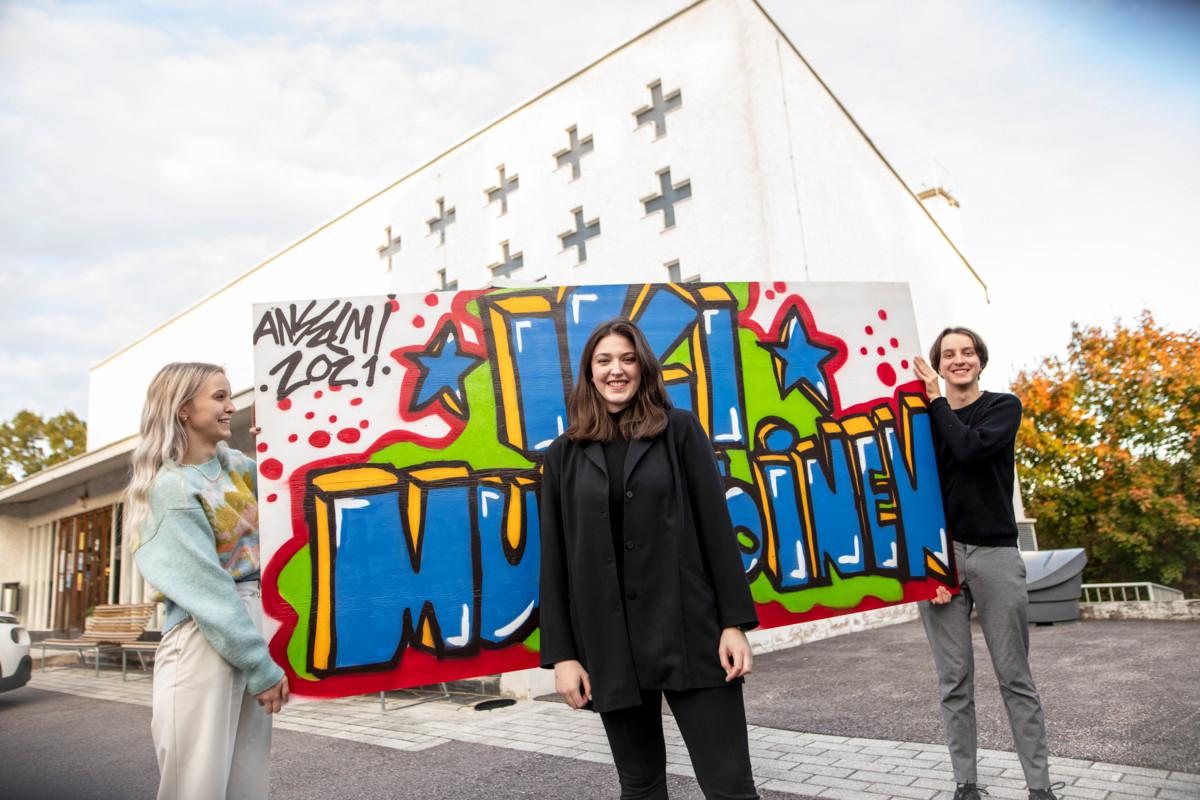 Daniela Davis (keskellä), 20, oli yksi riparin brändäämiseen osallistuneista seurakuntalaisista. Sana ”ikimuistoinen” valittiin kuvaamaan riparia ja sen taiteili graffitiin Anselmi Arajuuri. Graffittiseinää kantamassa Pihla Patokoski ja Aapo Juvakka.