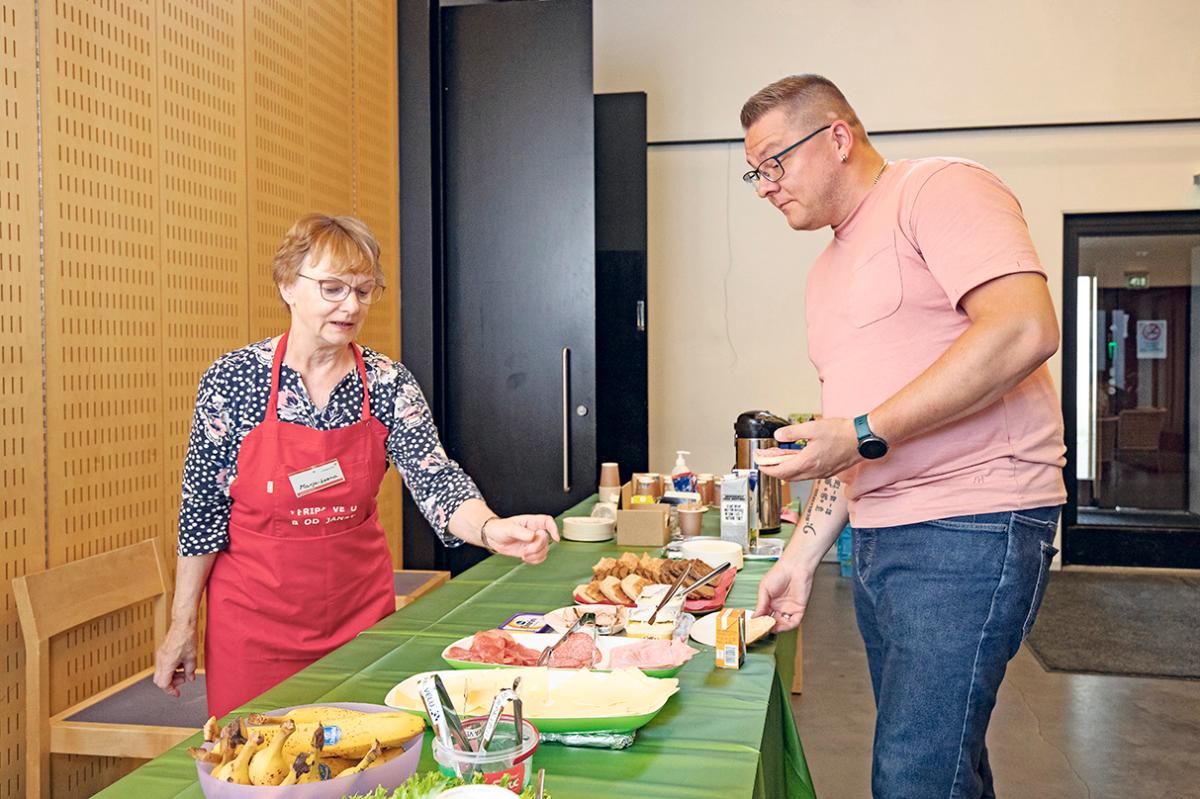 Juhani Viskari ei päässyt tällä kertaa luovuttamaan verta, sillä luomenpoistosta oli liian lyhyt aika. Hän otti välipalaa SPR:n vapaaehtoisen Marja-Leena Stenroosin kattamasta pöydästä.