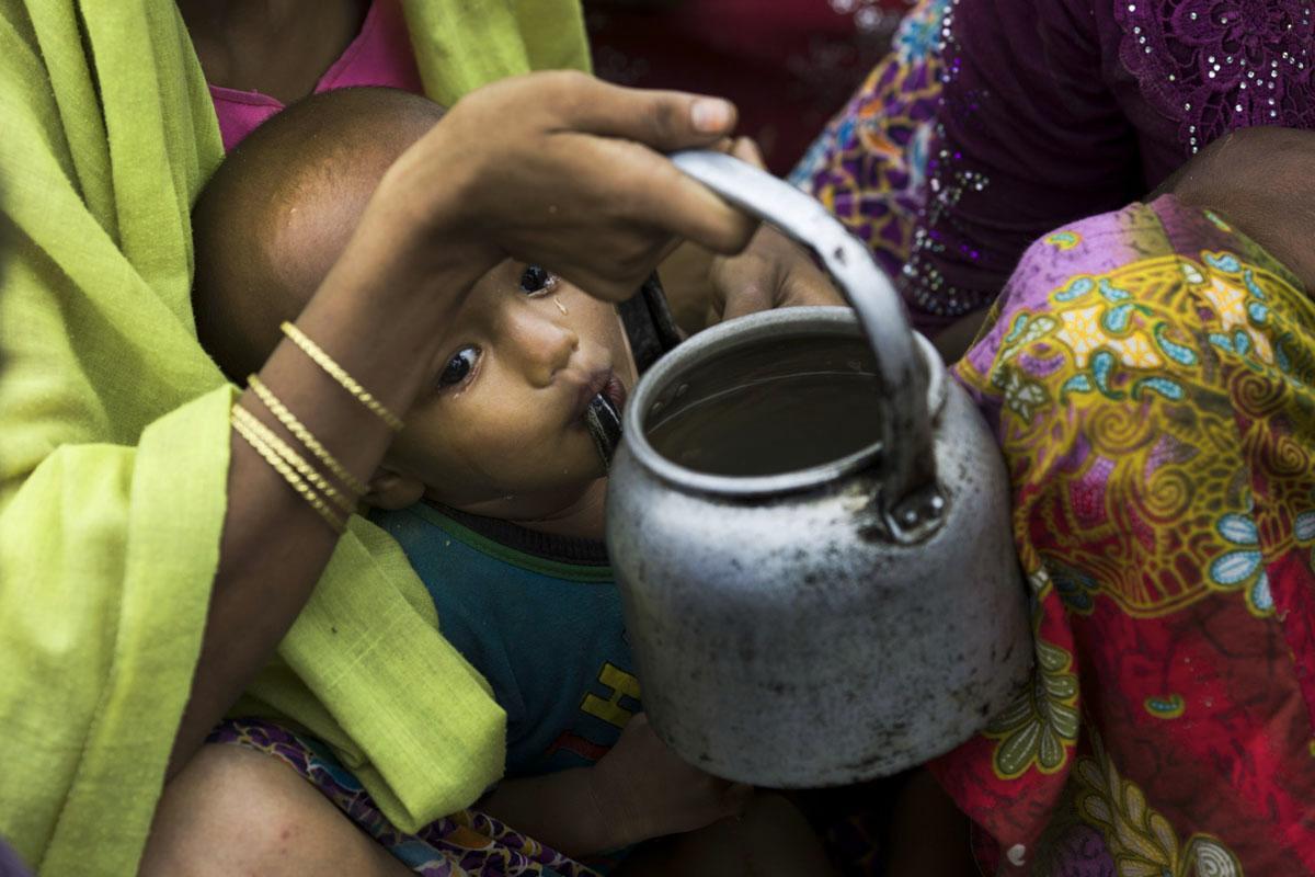 Myanmarin hallituksen vainoja pakeneva rohingya-lapsi juo vettä kahvipannusta. Elokuusta lähtien noin puolet rohingya-kansasta on paennut Bangladeshiin.